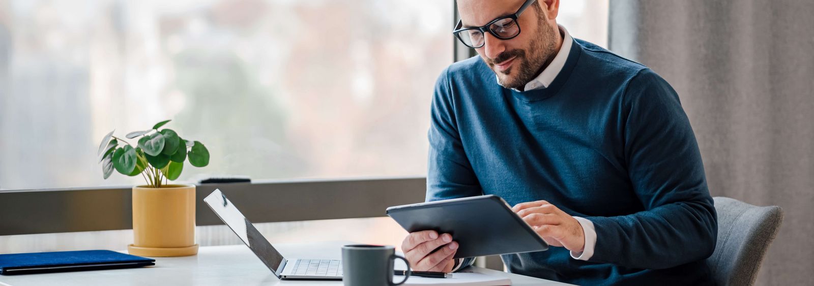 Man searches for a domain for his website on the tablet