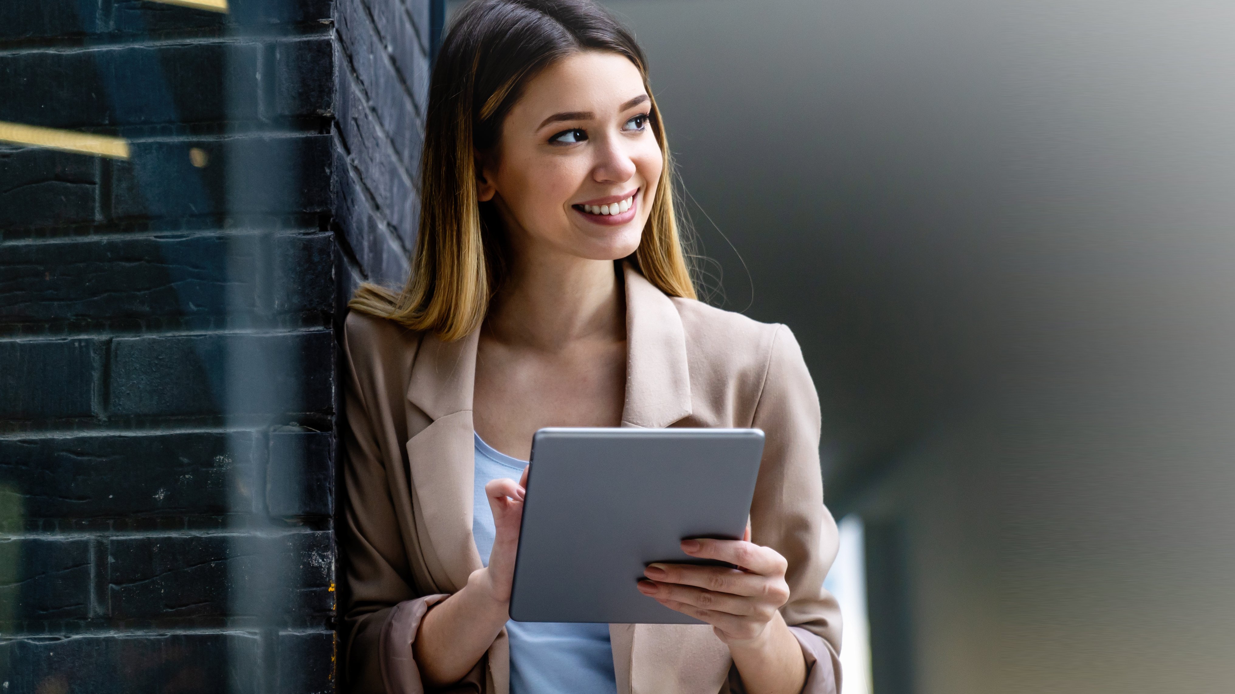 Woman happily checks her emails on the tablet
