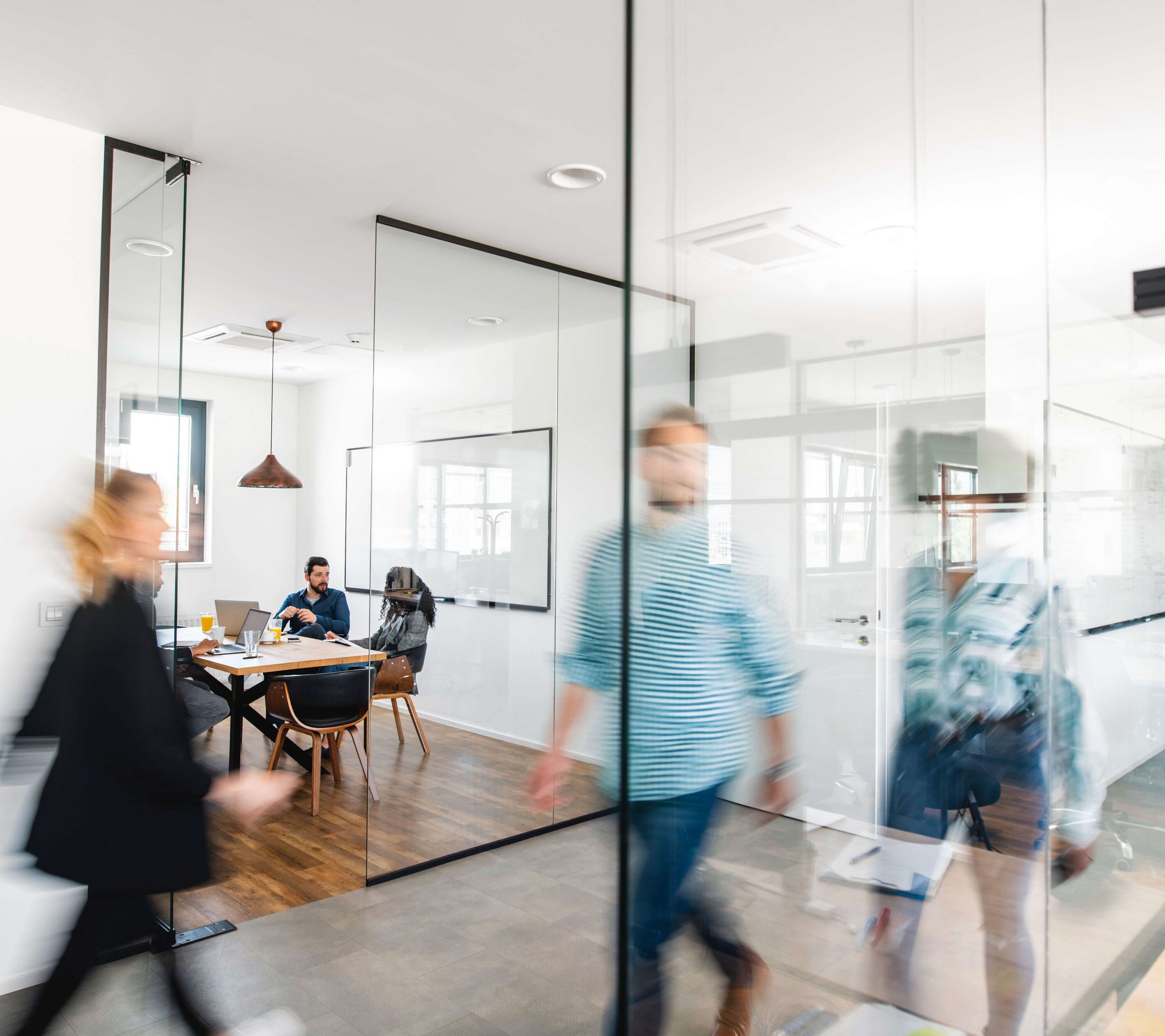 People are moving through an office