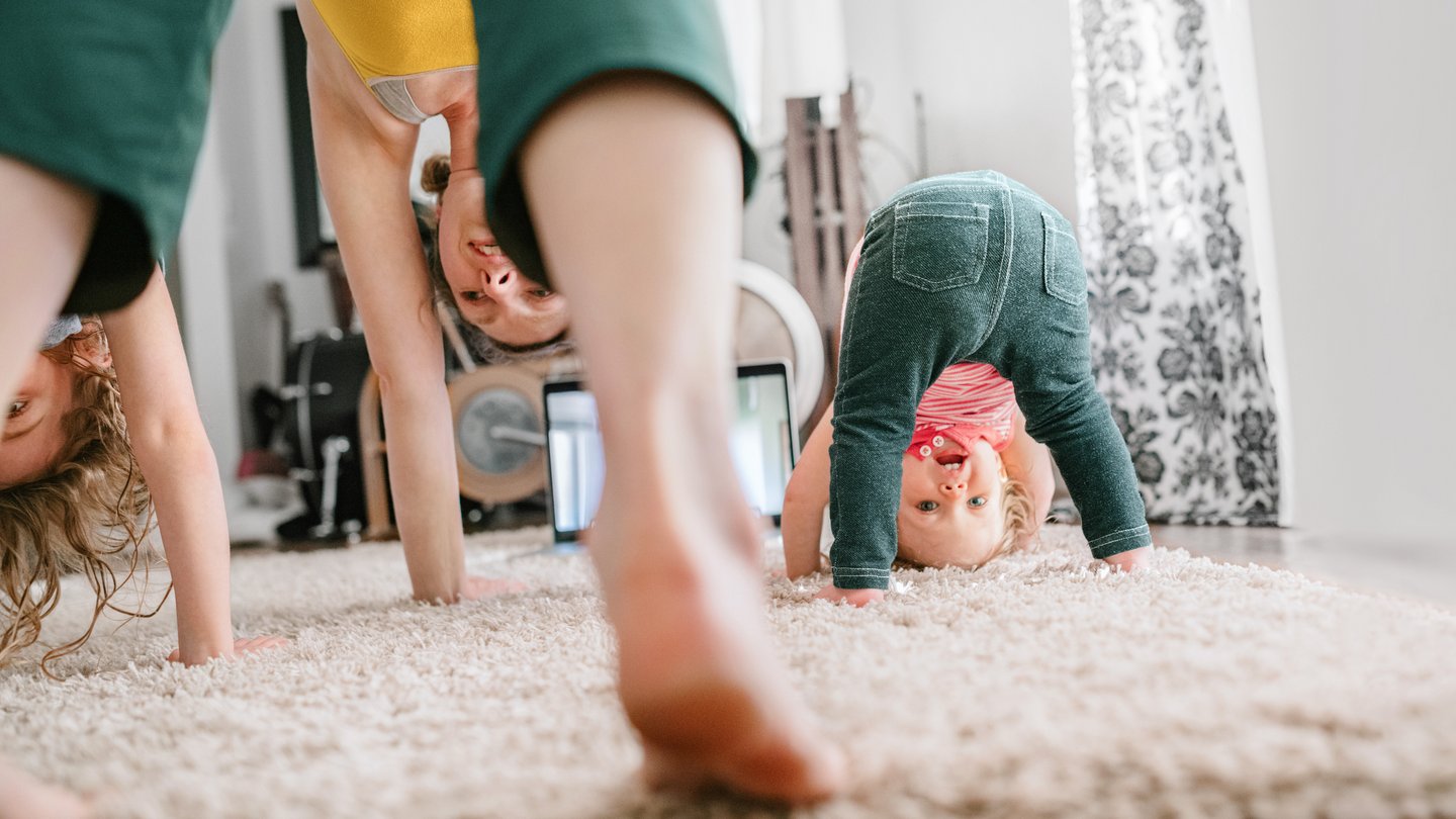Mother with children doing yoga at home