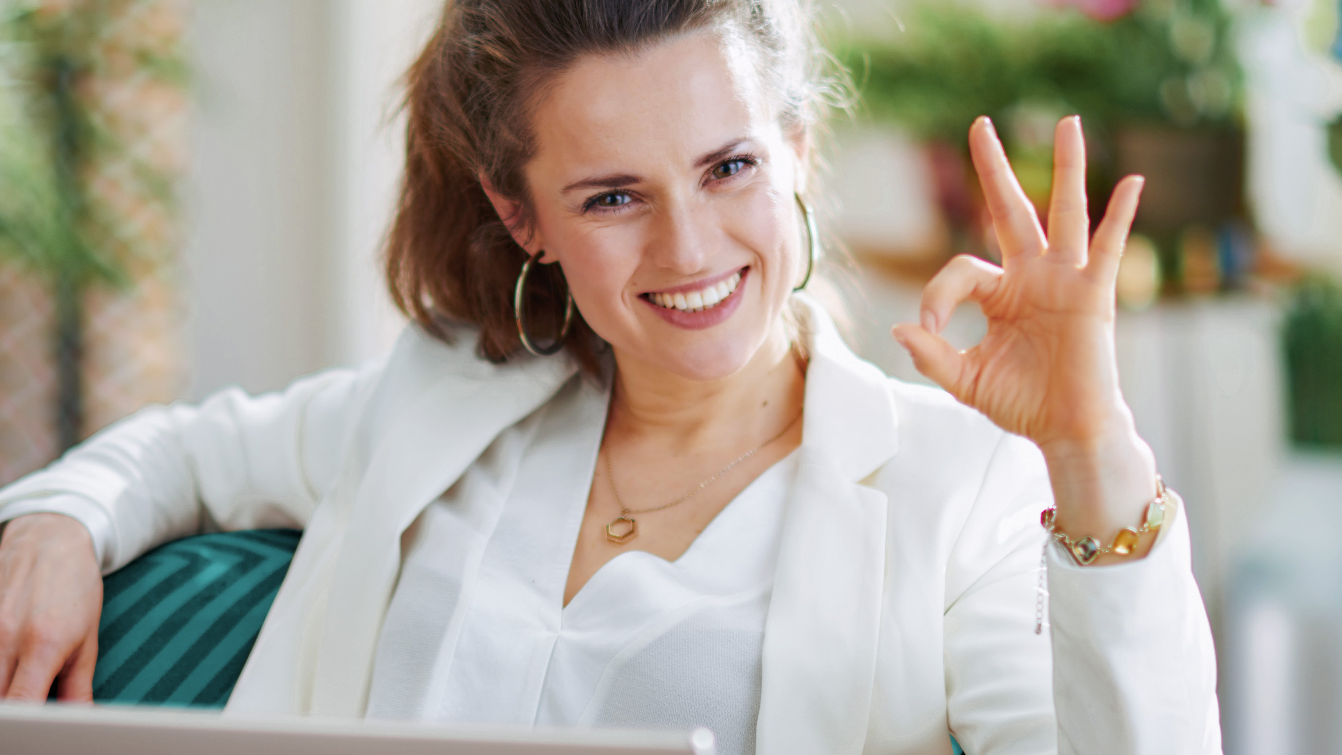 Woman sits at the computer and books web hosting