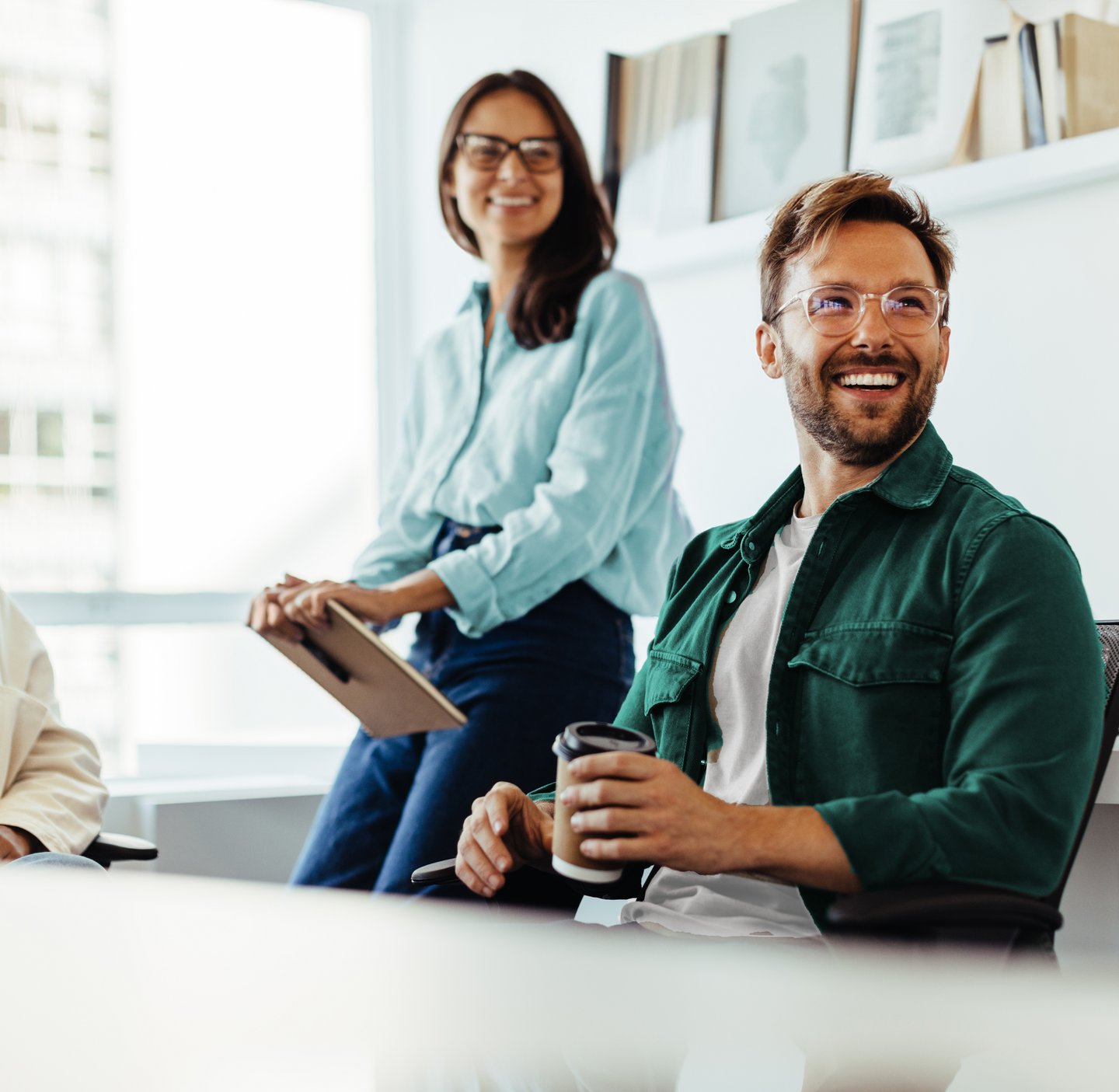  Two women and one man laughing in the office