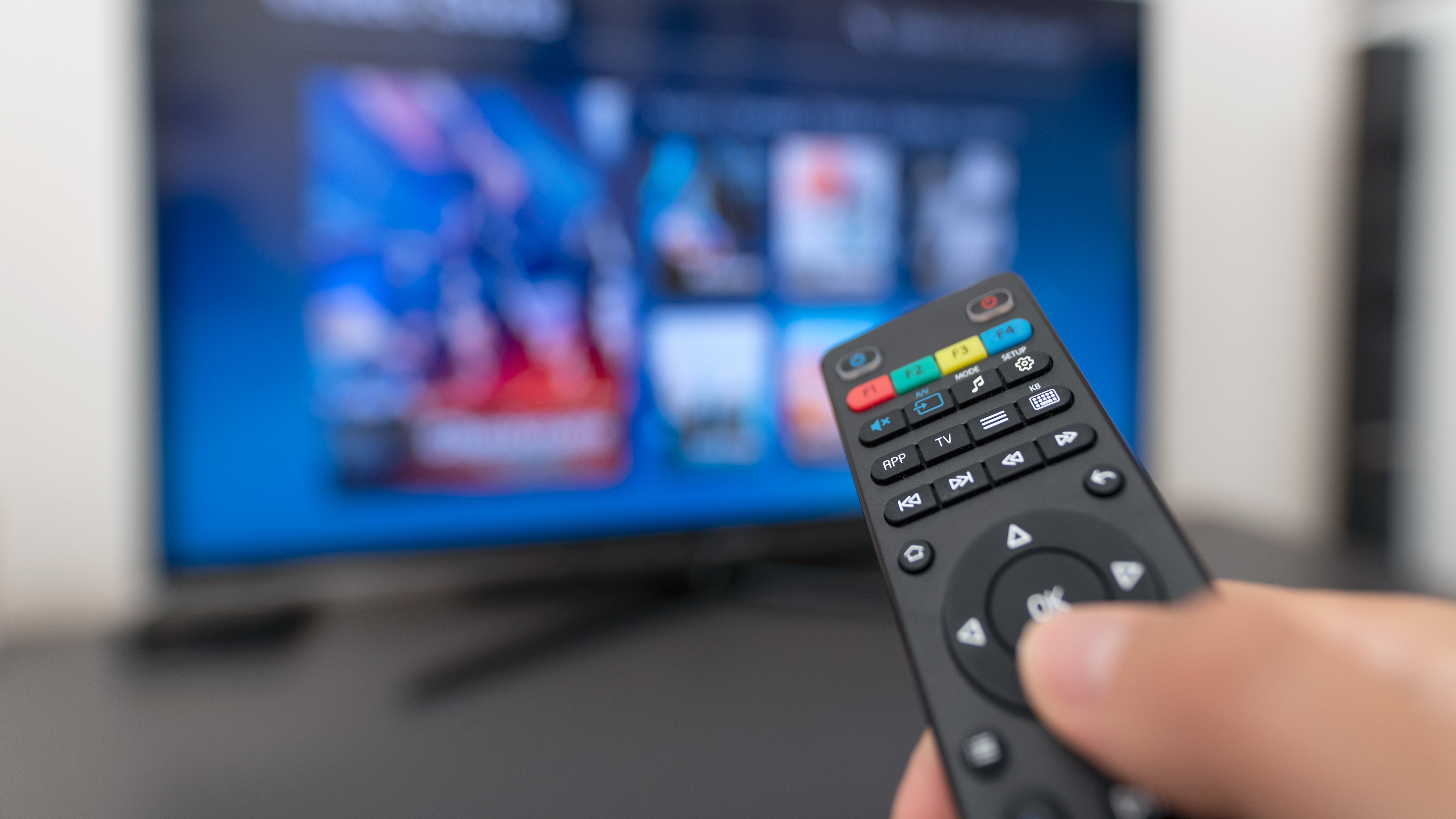 One person operates the remote control and watches TV from Green