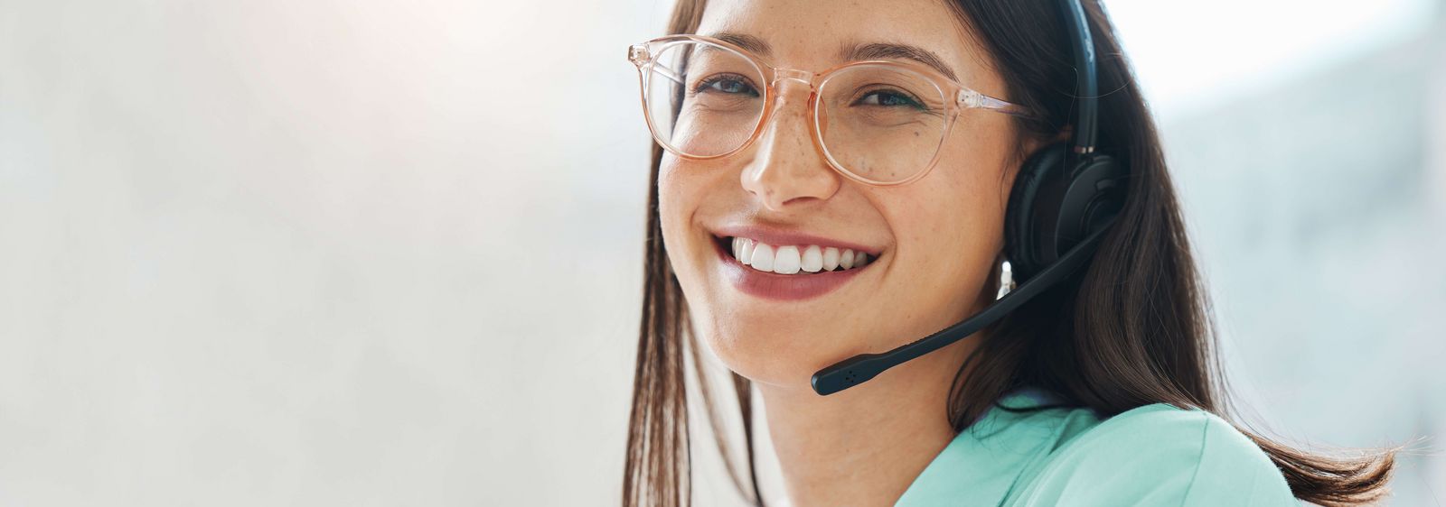 A young call centre representative greets a caller