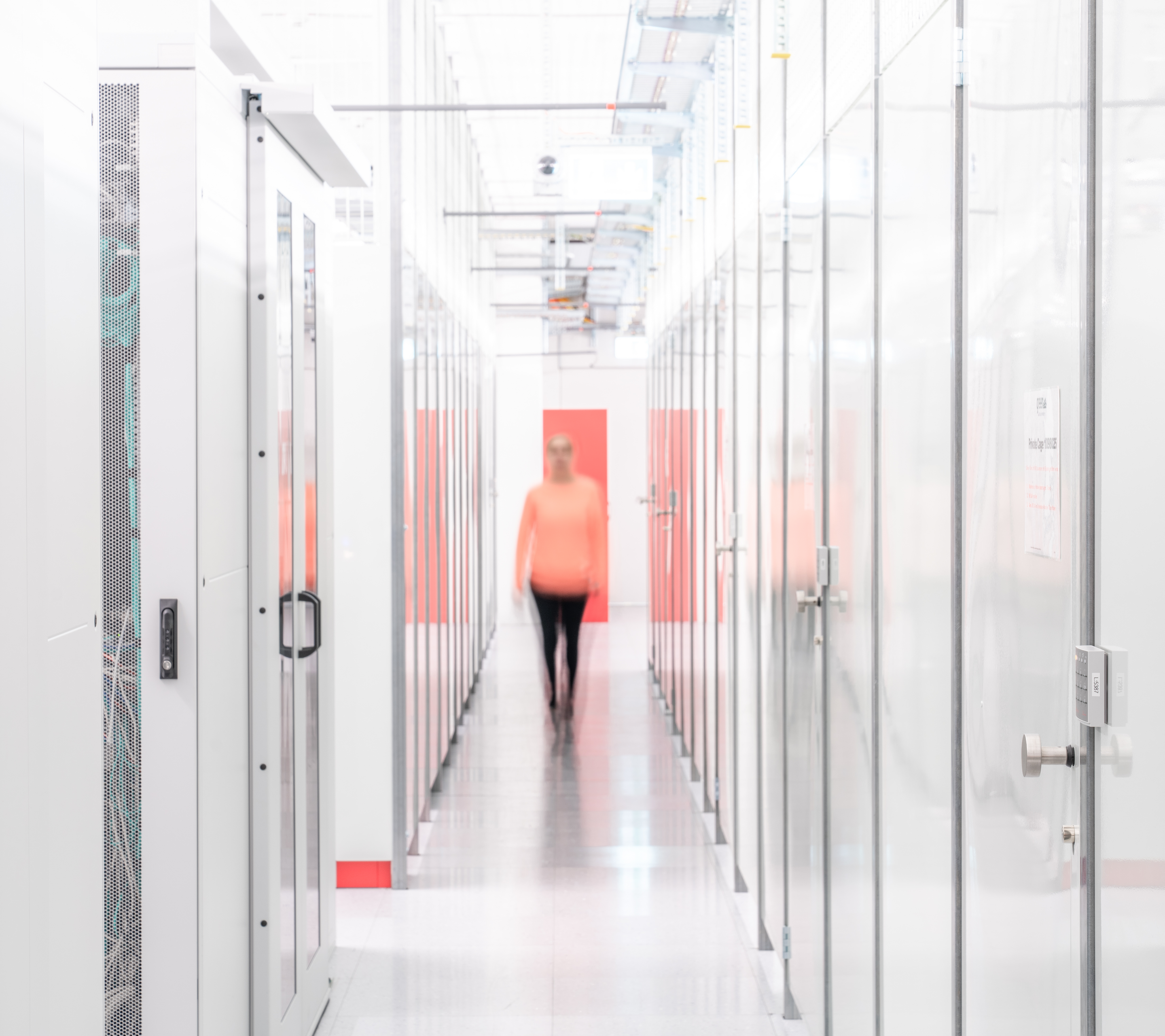 Datacenter Cage hallway with woman
